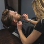 faceless-woman-cutting-beard-man_23-2147778905