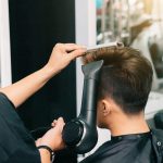 hands-unrecognizable-hairdresser-giving-male-customer-blowdry-with-hairdryer-comb_1098-20673